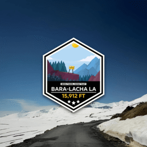 Bara-Lacha La 15,912 FT sticker showing snow, sun, trees, and mountain pass sign.