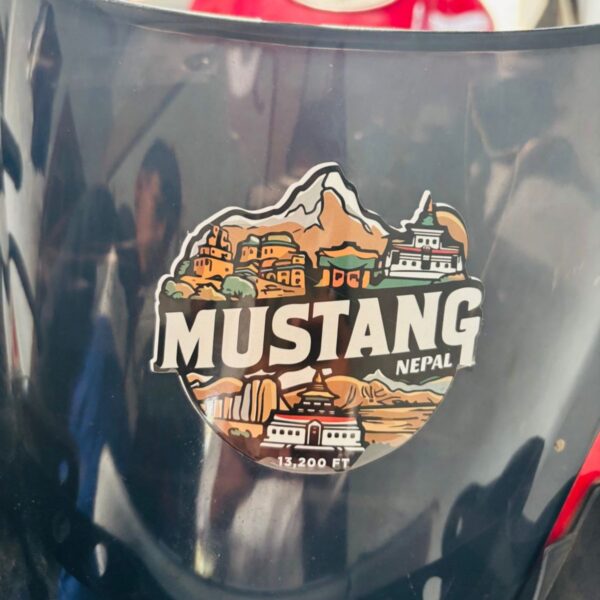 Mustang 13,200 FT sticker showing monasteries, temples, and mountains of Nepal in the bike visor.